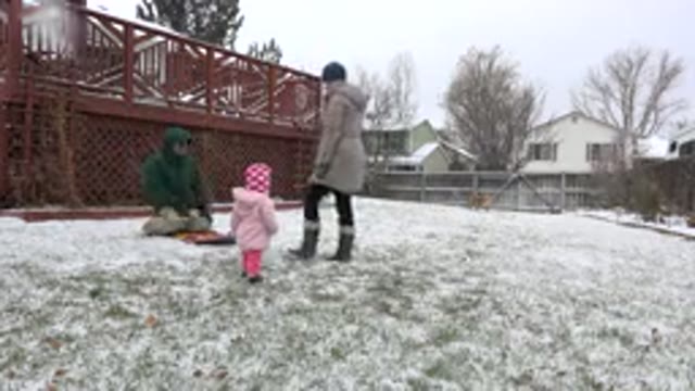 WESTMINSTER COLORADO-2015: Young Family Plays In The Snow As It Is Falling