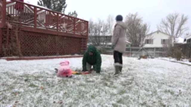 WESTMINSTER COLORADO-2015: Parents Playing With Baby In Snowy Backyard