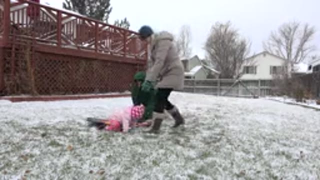 WESTMINSTER COLORADO-2015: Mom And Daughter Standing In A Yard With Snow