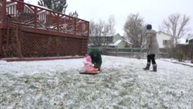 WESTMINSTER COLORADO-2015: Family In The Snow With Baby On The Ground Sledding