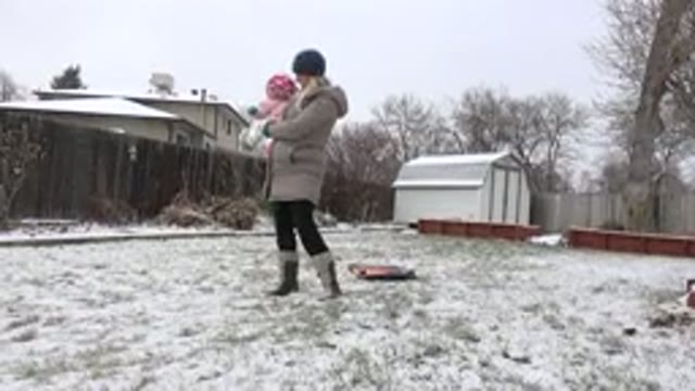 WESTMINSTER COLORADO-2015: A Mom Holding A Baby Playing With A Dog In Snowy Backyard