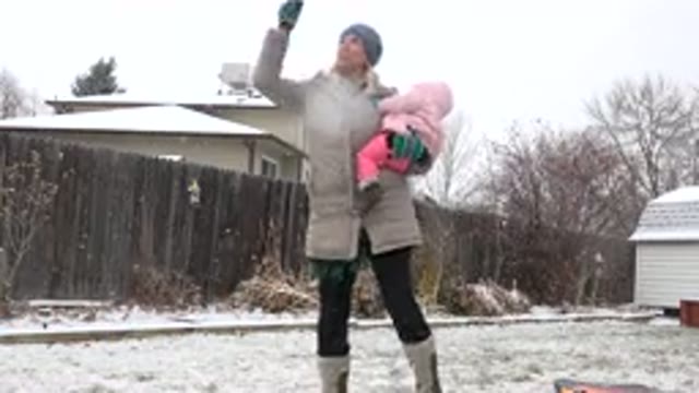 WESTMINSTER COLORADO-2015: Mother And Baby Play Fetch With Dog On A Snowy Day