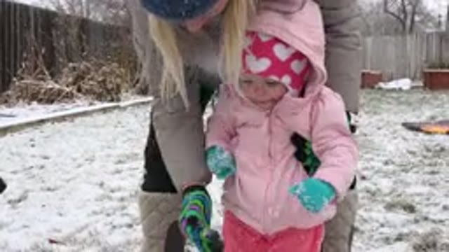 WESTMINSTER COLORADO-2015: Mom And Daughter Standing In The Yard While It Is Snowing