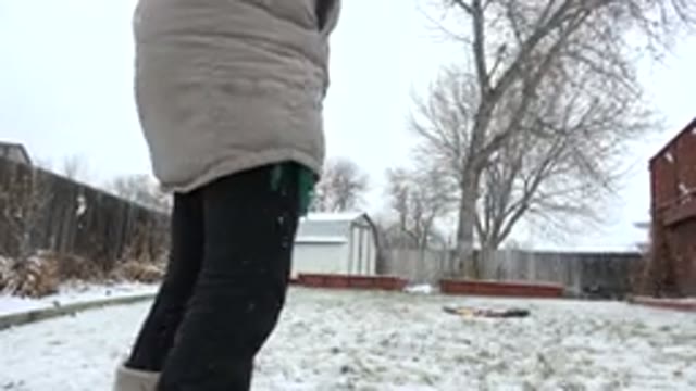 WESTMINSTER COLORADO-2015: Woman Wearing Tan Coat Picks Up Baby Wearing Pink