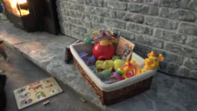 WESTMINSTER COLORADO-2015: Various Toys In A Basket Next To A Book In A Gray Room