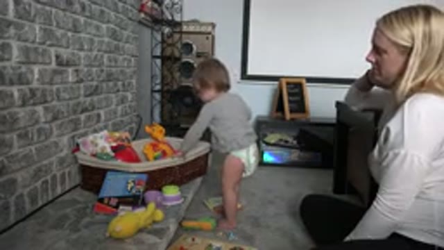 WESTMINSTER COLORADO-2015: Woman Wearing White Shirt Watches Toddler Wearing Grey