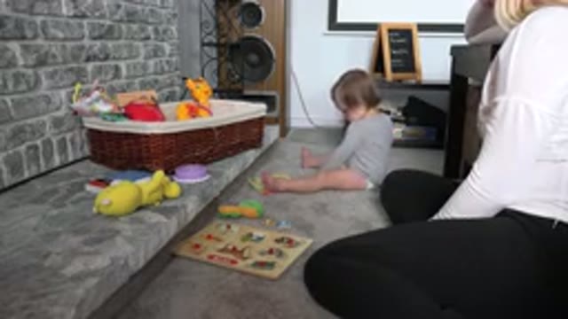 WESTMINSTER COLORADO-2015: White Baby Playing And Crawling On The Floor Next To