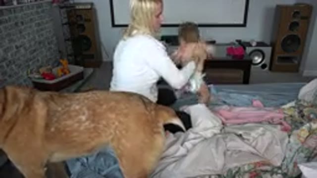 WESTMINSTER COLORADO-2015: Mother Carefully Lays Infant Down On Bed To Change