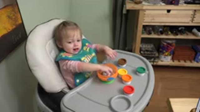 WESTMINSTER COLORADO-2015: Child Sitting In High Chair Banging Toys Against It