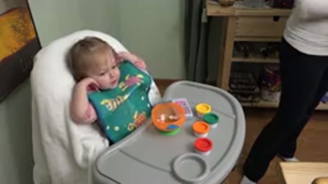 WESTMINSTER COLORADO-2015: Mother Feeding Her Baby and Watching TV