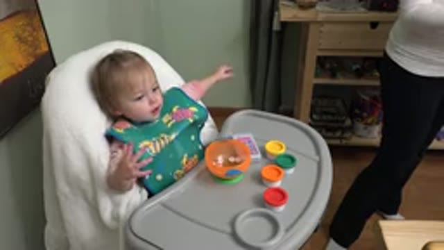 WESTMINSTER COLORADO-2015: Baby Sitting In A High Chair And Eating Food With Its Fingers
