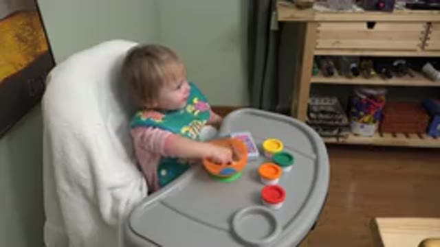 WESTMINSTER COLORADO-2015: Toddler Sitting Down And Eating A Bowl Of Food With Hands