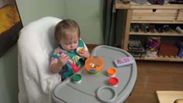 WESTMINSTER COLORADO-2015: Small Baby Sits in Highchair and Plays with Plastic Toys