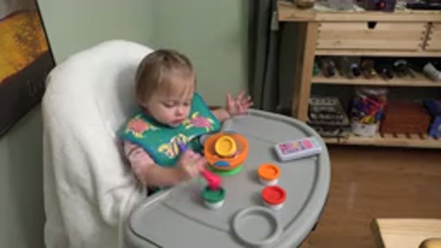 WESTMINSTER COLORADO-2015: The Baby Sitting In A High Chair Is Playing With Her