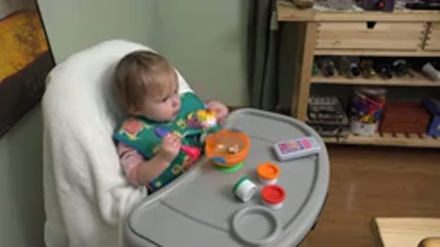 WESTMINSTER COLORADO-2015: Little Blond Baby In A Chair Putting A Small Pot In A Bowl