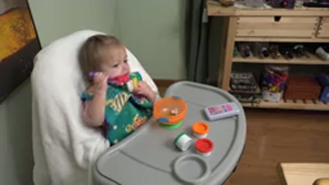 WESTMINSTER COLORADO-2015: Toddler In A High Chair Playing With Plastic Spoon