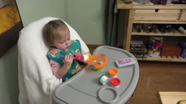 WESTMINSTER COLORADO-2015: Toddler Playing in Her Highchair with Spoon and Bowl