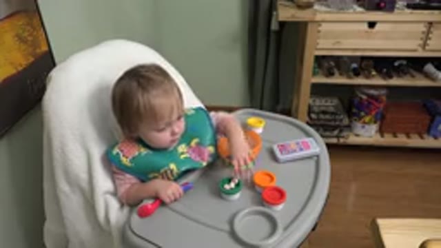 WESTMINSTER COLORADO-2015: Baby Sitting In A Chair And Playing With Toys She Has