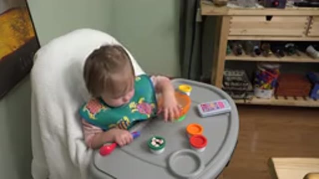 WESTMINSTER COLORADO-2015: A Blond Baby Sitting In A Baby Chair Wearing A Green Printed Bib