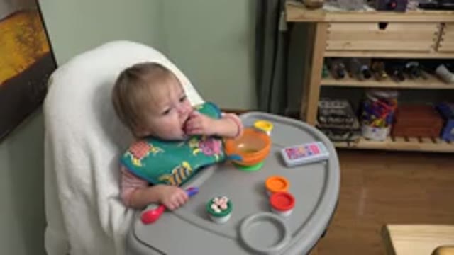 WESTMINSTER COLORADO-2015: Baby Girl Eating Finger Foods in High Chair with Toys in Kitchen