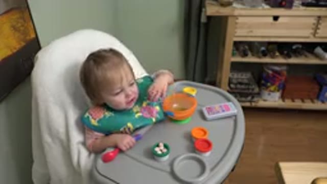 WESTMINSTER COLORADO-2015: Baby Eating Its Meal In Front Of Her
