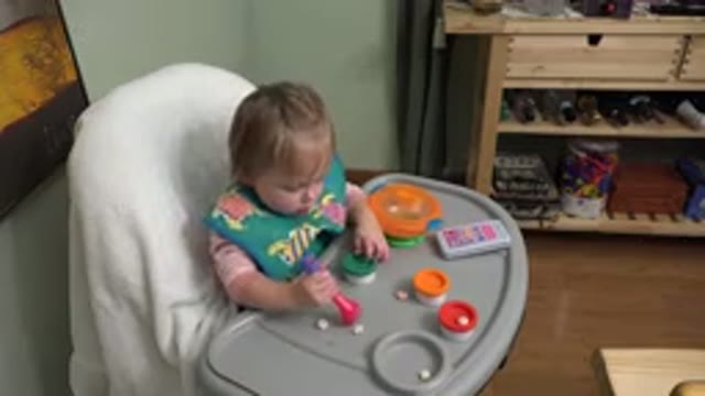 WESTMINSTER COLORADO-2015: Baby Girl Sitting In High Chair And Playing With Play Dough