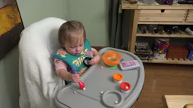 WESTMINSTER COLORADO-2015: A Baby In A High Chair Trying To Pick Up Some Food