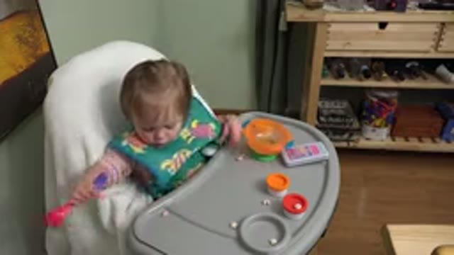 WESTMINSTER COLORADO-2015: A Baby Eating Their Food While Sitting In A High Chair