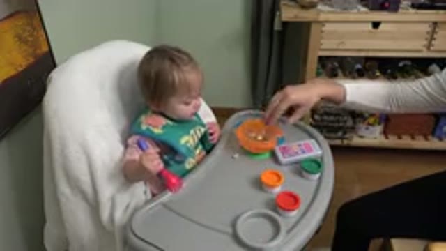 WESTMINSTER COLORADO-2015: Person Wearing White Shirt Gives Toddler Snacks In