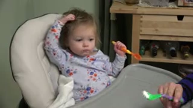 WESTMINSTER COLORADO-2015: Feeding Spoonful Of Food To A Happy Girl Toddler In A