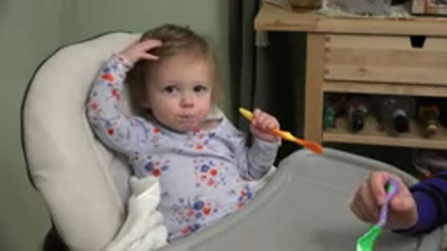 WESTMINSTER COLORADO-2015: A Baby Eating Food From A Spoon At A Booster Seat