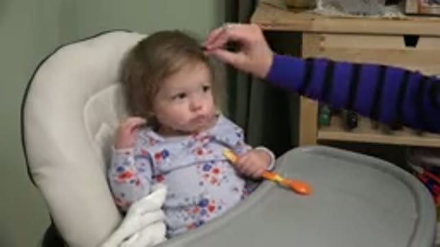 WESTMINSTER COLORADO-2015: A Baby In A Booster Seat Being Gently Touched And Adjusted