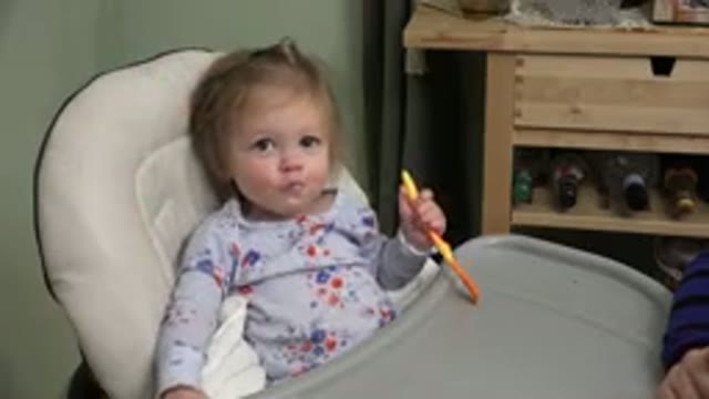 WESTMINSTER COLORADO-2015: Little Girl in Booster Seat Eating with Spoon