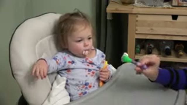WESTMINSTER COLORADO-2015: Parent Feeding Child with Spoon, Child Reaches for Spoon