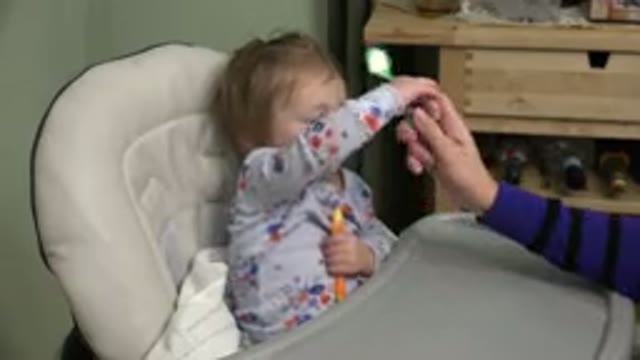 WESTMINSTER COLORADO-2015: A Toddler Eating Food From a Spoon Given by an Adult