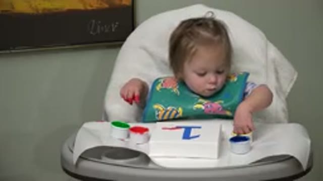 WESTMINSTER COLORADO-2015: Blonde Baby Smiling While Playing With Paint