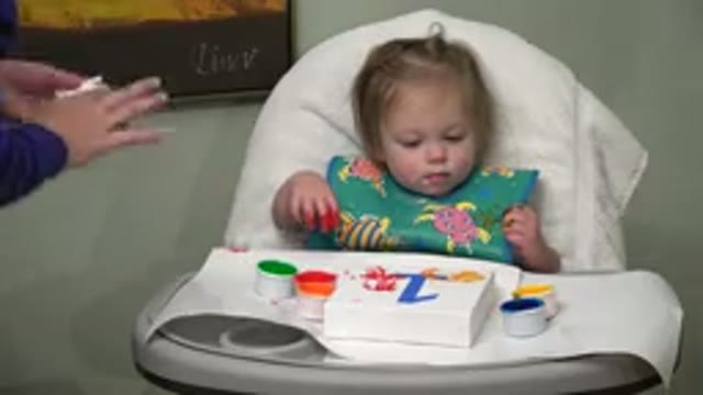 WESTMINSTER COLORADO-2015: Young Girl Sitting In A Baby Chair While Playing With Ink