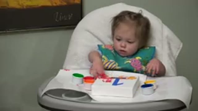 WESTMINSTER COLORADO-2015: Blonde Baby Girl Painting in High-Chair with Colored Apron