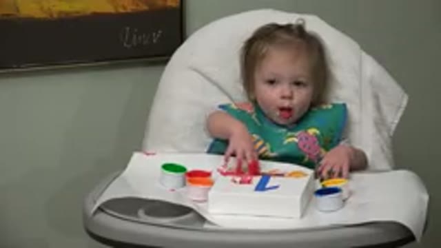 WESTMINSTER COLORADO-2015: Blonde Baby With Blue Eyes Playing With Paints While Sitting in Chair