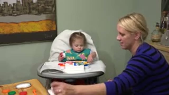 WESTMINSTER COLORADO-2015: Mother Assists Baby Girl in Highchair Creating Art