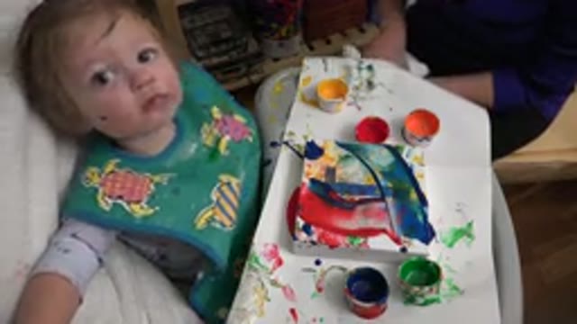 WESTMINSTER COLORADO-2015: Infant With Paint Smock Fingerprinting In Highchair