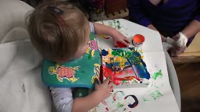 WESTMINSTER COLORADO-2015: Little Girl Playing With Messy Finger Paint