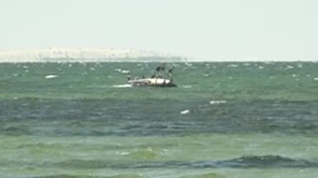 SAN CARLOS BCS MEXICO-2022: Boat with People Navigating Choppy Ocean Waters