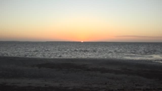 SAN CARLOS BCS MEXICO-2022: Gentle Waves Lapping Sandy Beach at Sunset