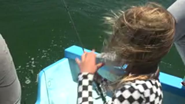 LA BOCANA BCS MEXICO-2022: A Young Girl Fishing on a Small Blue Boat