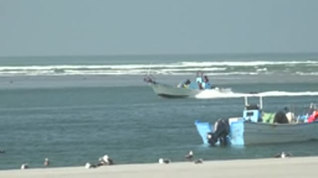 LA BOCANA BCS MEXICO-2022: Boats Moving near Sandy Beach with Seagulls and Car