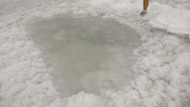 GUERRERO NEGRO BCS MEXICO-2022: Child Standing on White Salt Flat near Water Pool