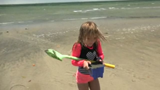SAN CARLOS BCS MEXICO-2022: Child Playing with Shovel and Bucket on Sandy Beach