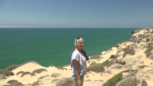 SAN QUINTIN BC MEXICO-2022: Woman and Child on Coastal Cliff Overlooking Ocean