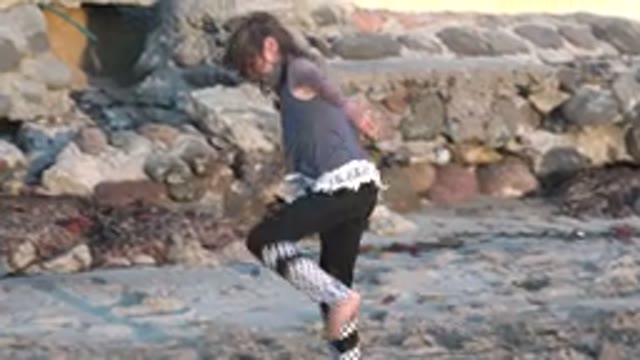 SAN CARLOS BCS MEXICO-2022: Child Performing Cartwheels on Sandy Beach
